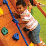 boy on rock wall