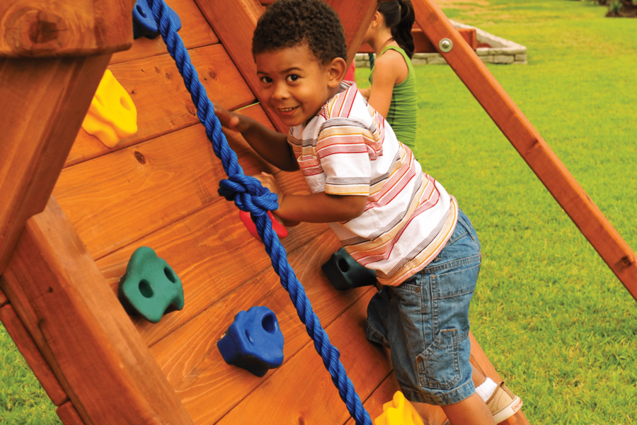 boy on rock wall